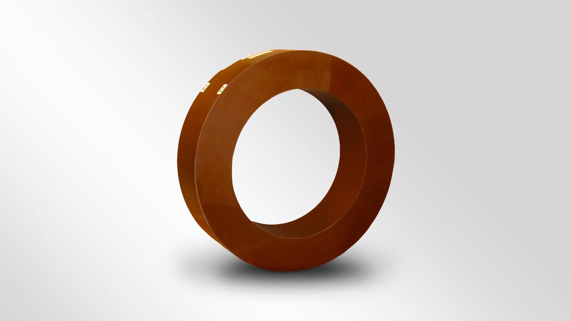 A copper-colored toroidal cast resin current transformer made of metal for use in generator leads up to 36kV